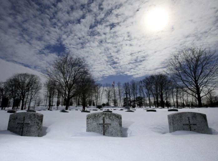 Some of the headstones at Beechwood Cemetery, particularly in the older military section, are almost completely covered in snow these days, the names of those interred below them temporarily hidden from view. PHOTO BY JULIE OLIVER /POSTMEDIA