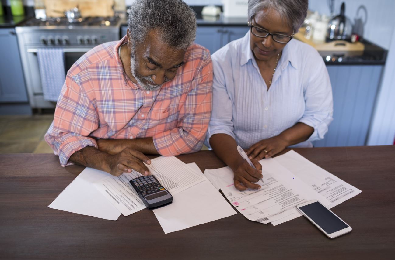 Older couple discussing wills at kitchen table