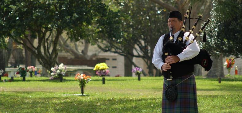 A musician playing pipes on remembrance day | Beechwood Cemetery